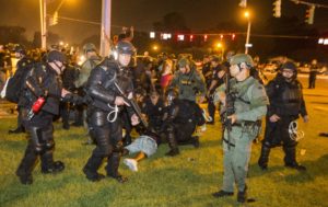 BATON ROUGE, LA -JULY 09: Baton Rouge police rush the crowd of protesters and start making arrest on July 9, 2016 in Baton Rouge, Louisiana. Alton Sterling was shot by a police officer in front of the Triple S Food Mart in Baton Rouge on July 5th, leading the Department of Justice to open a civil rights investigation. (Photo by Mark Wallheiser/Getty Images)